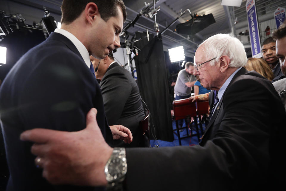 South Bend Mayor Pete Buttigieg, left, and Sen. Bernie Sanders, I-Vt., right, pass as they talk to the media in the spin room following the Democratic presidential primary debate hosted by ABC on the campus of Texas Southern University Thursday, Sept. 12, 2019, in Houston. (AP Photo/Eric Gay)