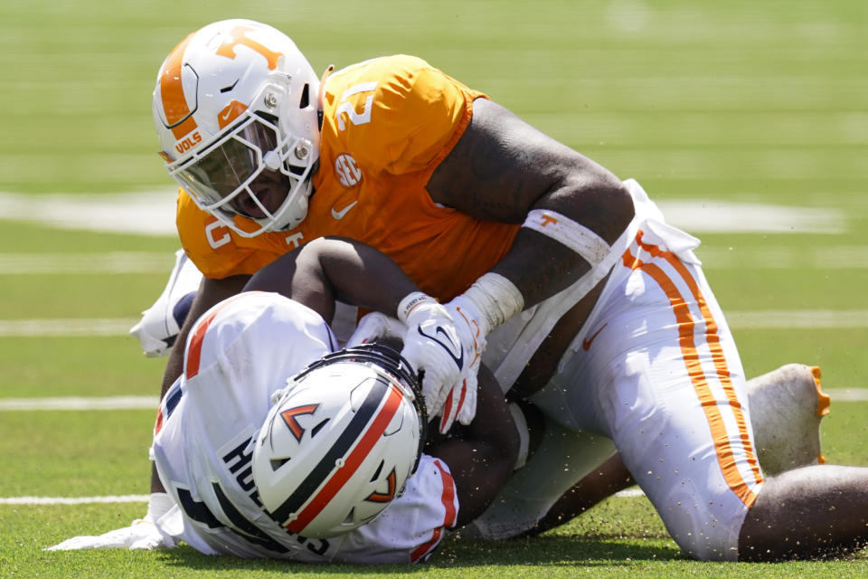 Tennessee defensive lineman Omari Thomas, top, tackles Virginia running back Mike Hollins in the first half of an NCAA college football game Saturday, Sept. 2, 2023, in Nashville, Tenn. (AP Photo/George Walker IV)