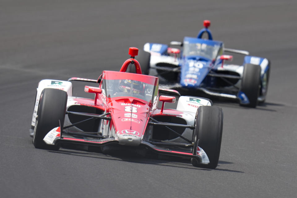 Marcus Ericsson, of Sweden, leads Alex Palou, of Spain, through the first turn during practice for the Indianapolis 500 auto race at Indianapolis Motor Speedway in Indianapolis, Thursday, May 18, 2023. (AP Photo/Michael Conroy)