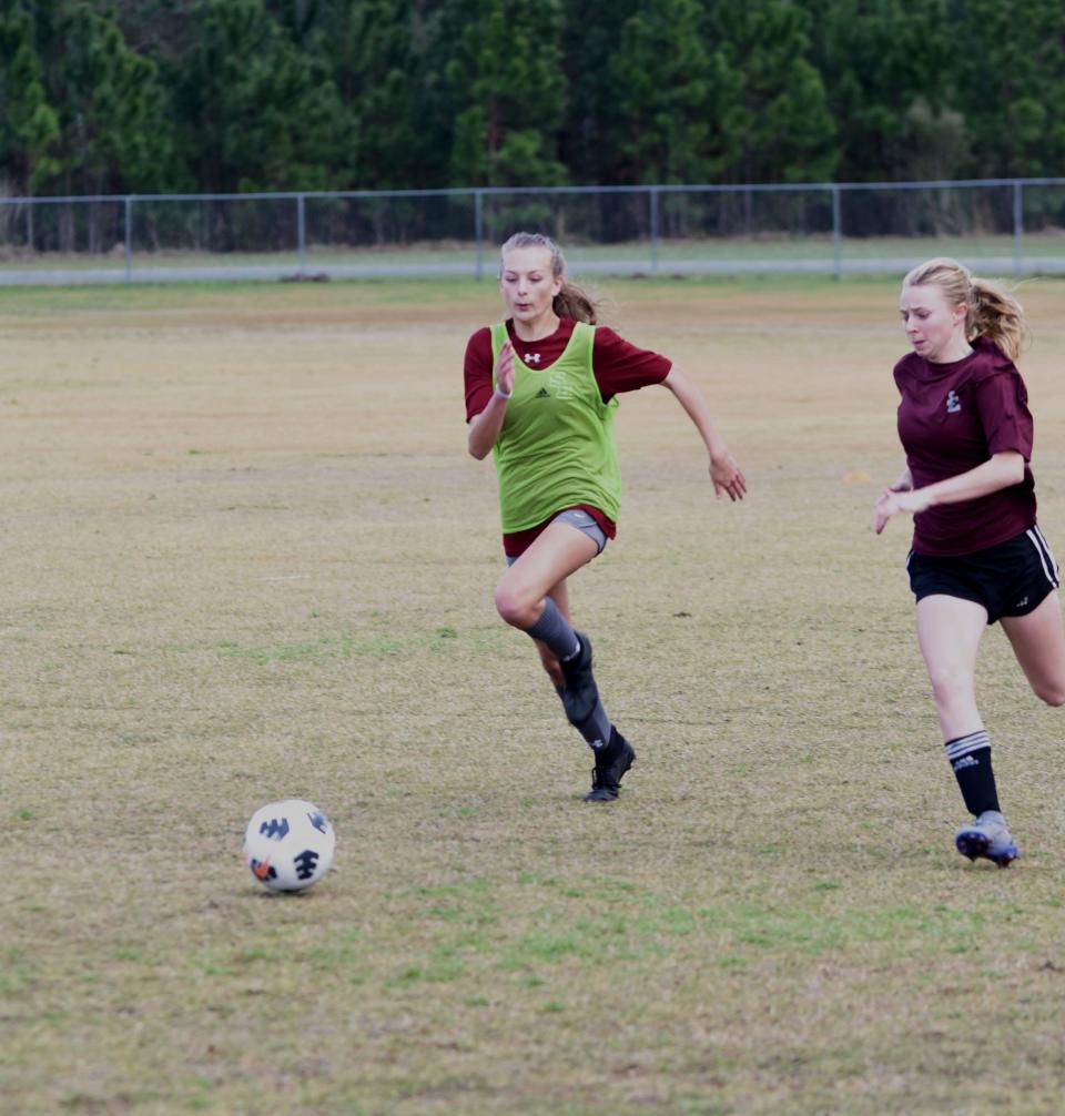 South Effingham High School soccer player Anna Dorch, left, works on offensive drills during a recent practice.