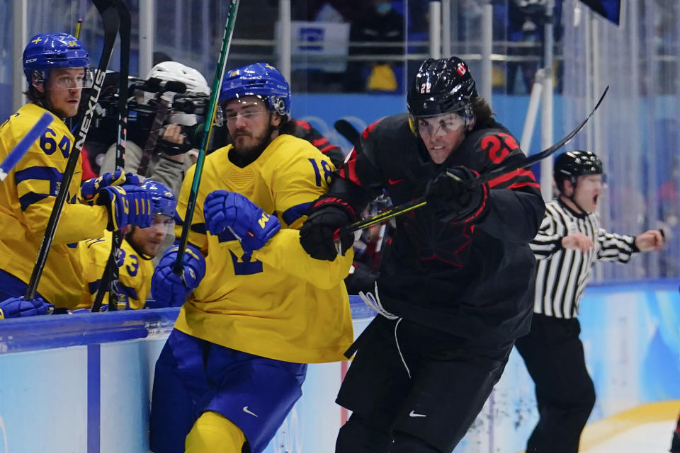 Canada's Owen Power (22) skates past Sweden's Dennis Everberg (18) during a men's quarterfinal hockey game at the 2022 Winter Olympics, Wednesday, Feb. 16, 2022, in Beijing. (AP Photo/Matt Slocum)