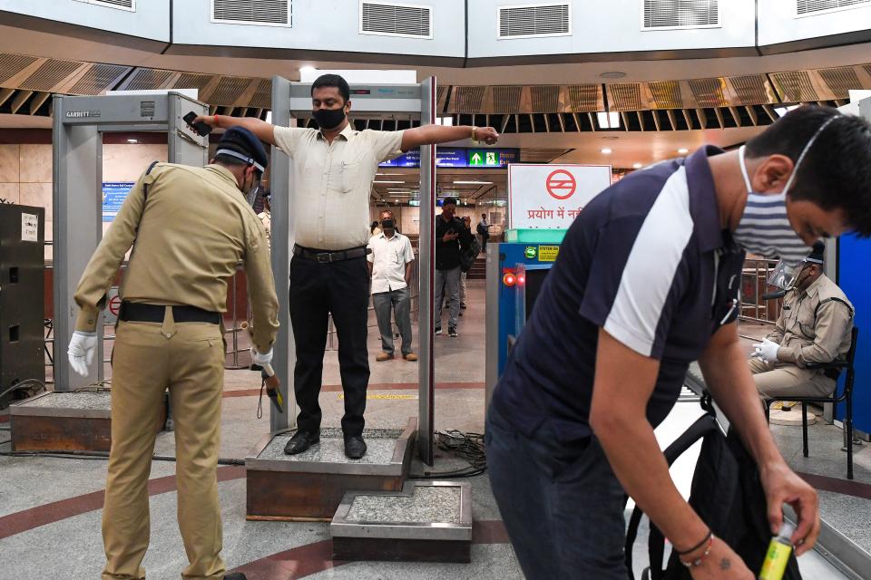 Commuters arrive in a metro station after Delhi Metro Rail Corporation (DMRC) resumed services in New Delhi on September 7, 2020. (Photo by PRAKASH SINGH/AFP via Getty Images)