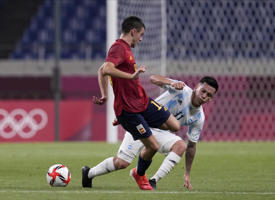 Spain's Pedri Gonzalez, left, and Argentina's Esequiel Barco battle for the ball during a men's soccer match at the 2020 Summer Olympics, Wednesday, July 28, 2021, in Saitama, Japan. (AP Photo/Martin Mejia)