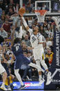 Utah Jazz center Rudy Gobert (27) defends against Dallas Mavericks forward Dorian Finney-Smith (10) in the second half during an NBA basketball game Saturday, Jan. 25, 2020, in Salt Lake City. (AP Photo/Rick Bowmer)