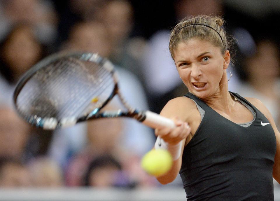Sara Errani of Italy returns the ball to Russia's Maria Sharapova during their semifinal match at the Porsche tennis Grand Prix in Stuttgart, Germany, Saturday, April 26, 2014. Sharapova won the match with 6-1 and 6-2. (AP Photo/dpa, Bernd Weissbrod)