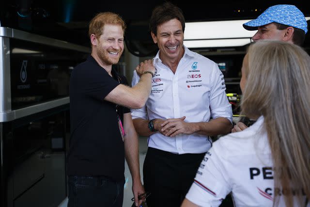 <p>Chris Graythen/Getty</p> Prince Harry, Duke of Sussex speaks to Mercedes GP Executive Director Toto Wolff before the F1 Grand Prix of the United States on October 22.
