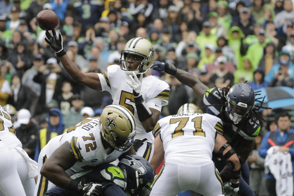 FILE- In this Sunday, Sept. 22, 2019, file photo, New Orleans Saints quarterback Teddy Bridgewater passes as Saints' Terron Armstead (72) and Ryan Ramczyk (71) hold off Seattle Seahawks outside linebacker Jadeveon Clowney, upper right, during the first half of an NFL football game in Seattle. Sundays game against the Dallas Cowboys could be an important game in the overall NFC playoff scheme, particularly if Bridgewater remains effective at quarterback until Brees is healthy. (AP Photo/Ted S. Warren, File)