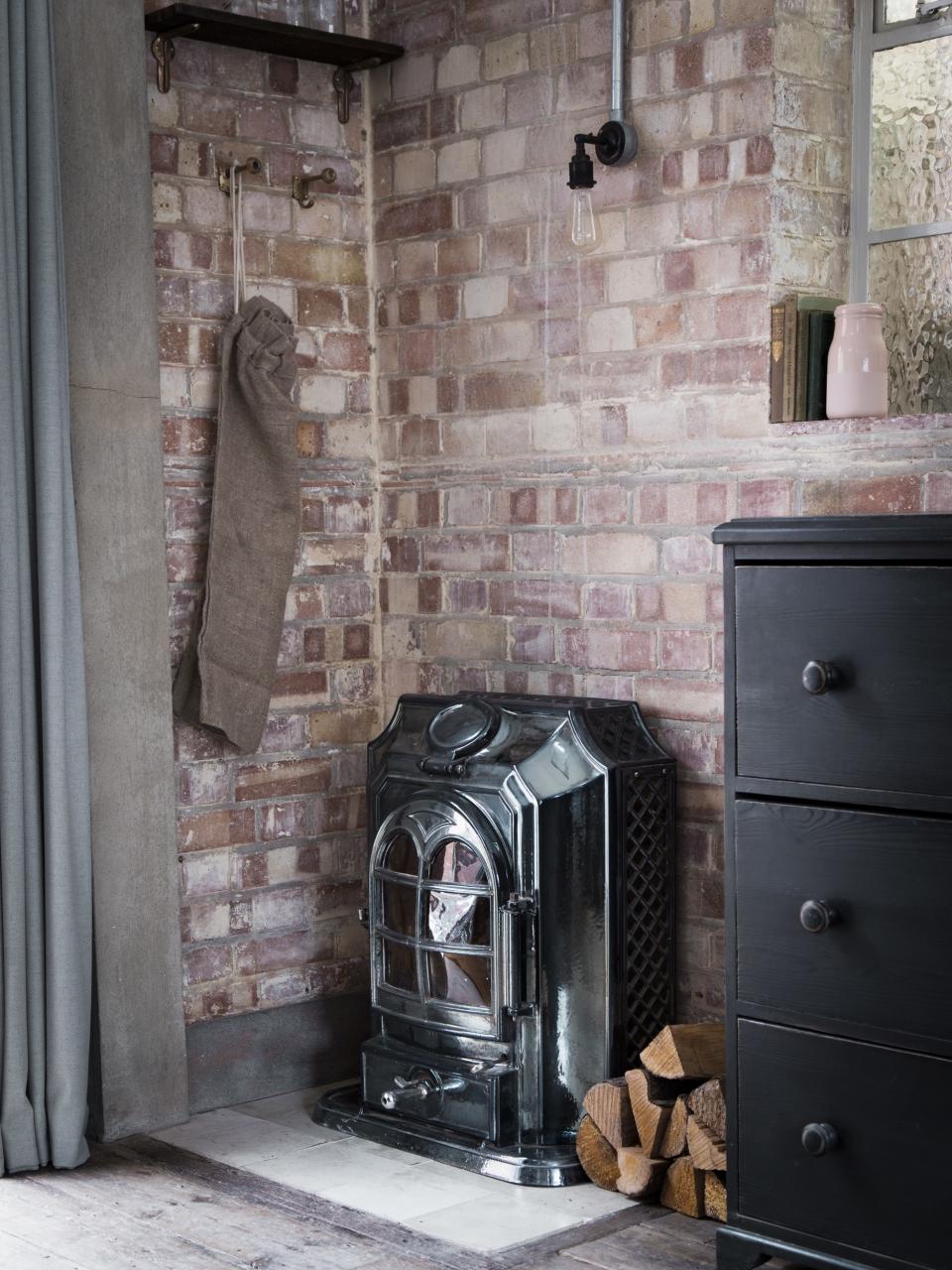 An antique wood-burning stove, salvaged from the home, was restored and installed to warm the space.