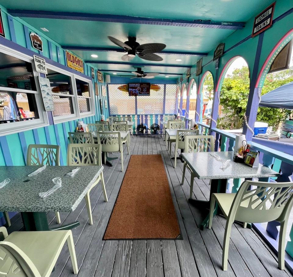 Guests can sit on the porch, under umbrella-covered tables, inside or at the bar at RC Otter's on Captiva.