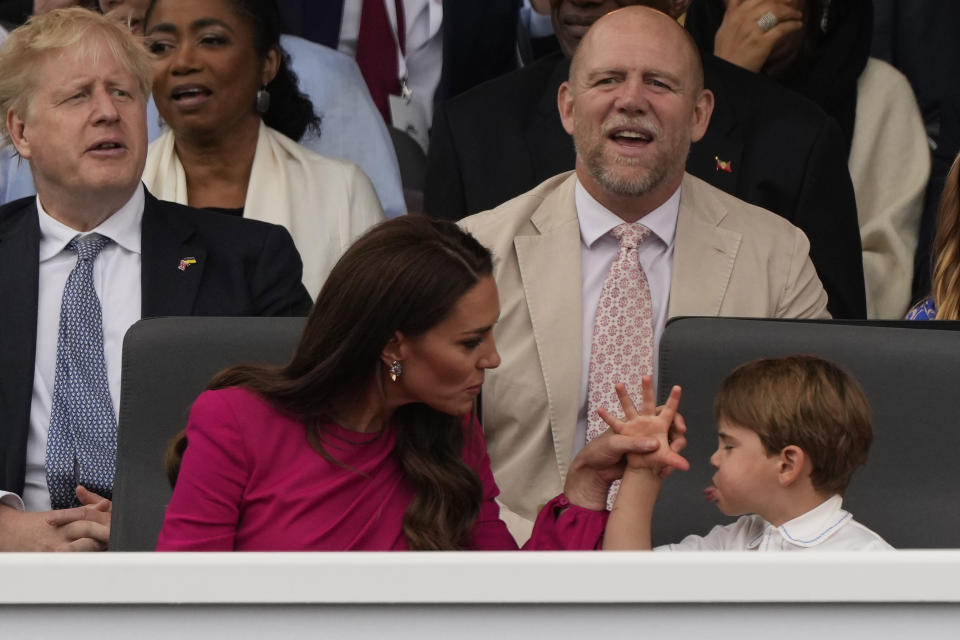 The Duchess of Cambridge and Prince Louis during the pageant as Boris Johnson and Mike Tindall watch on. (PA)