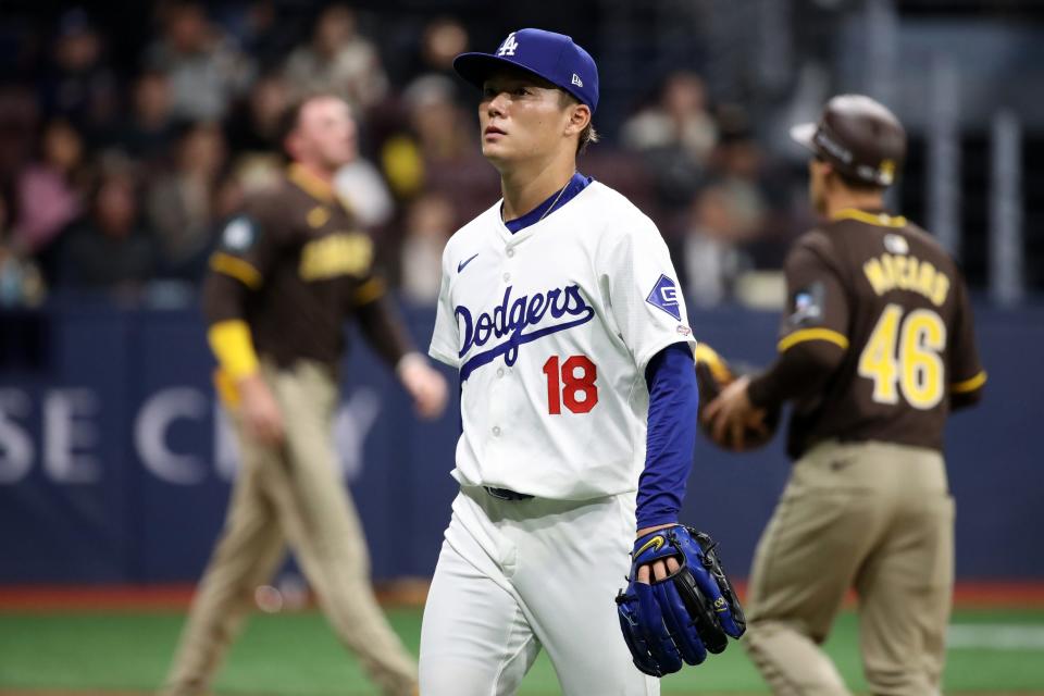 Yoshinobu Yamamoto walk off the mound after giving up five earned runs in the first inning.