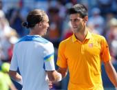 Aug 22, 2015; Cincinnati, OH, USA; Alexandr Dolgopolov (left) shakes hands with Novak Djokovic (SRB) after their match in the semifinals during the Western and Southern Open tennis tournament at the Linder Family Tennis Center. Mandatory Credit: Aaron Doster-USA TODAY Sports