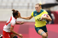 <p>Maddison Levi of Team Australia fends away Miyu Shirako of Team Japan on her way to score a try in the Women’s pool C match between Team Australia and Team Japan during the Rugby Sevens on day six of the Tokyo 2020 Olympic Games at Tokyo Stadium on July 29, 2021 in Chofu, Tokyo, Japan. (Photo by Dan Mullan/Getty Images)</p> 