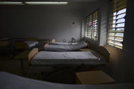 Beds fill a classroom at the Carlos Escobar Lopez vocational school which will be used as a shelter during this year's hurricane season in Loiza, Puerto Rico, Thursday, May 28, 2020. Caribbean islands have rarely been so vulnerable as an unusually active hurricane season threatens a region still recovering from recent storms as it fights a worsening drought and a pandemic that has drained budgets and muddled preparations. (AP Photo/Carlos Giusti)