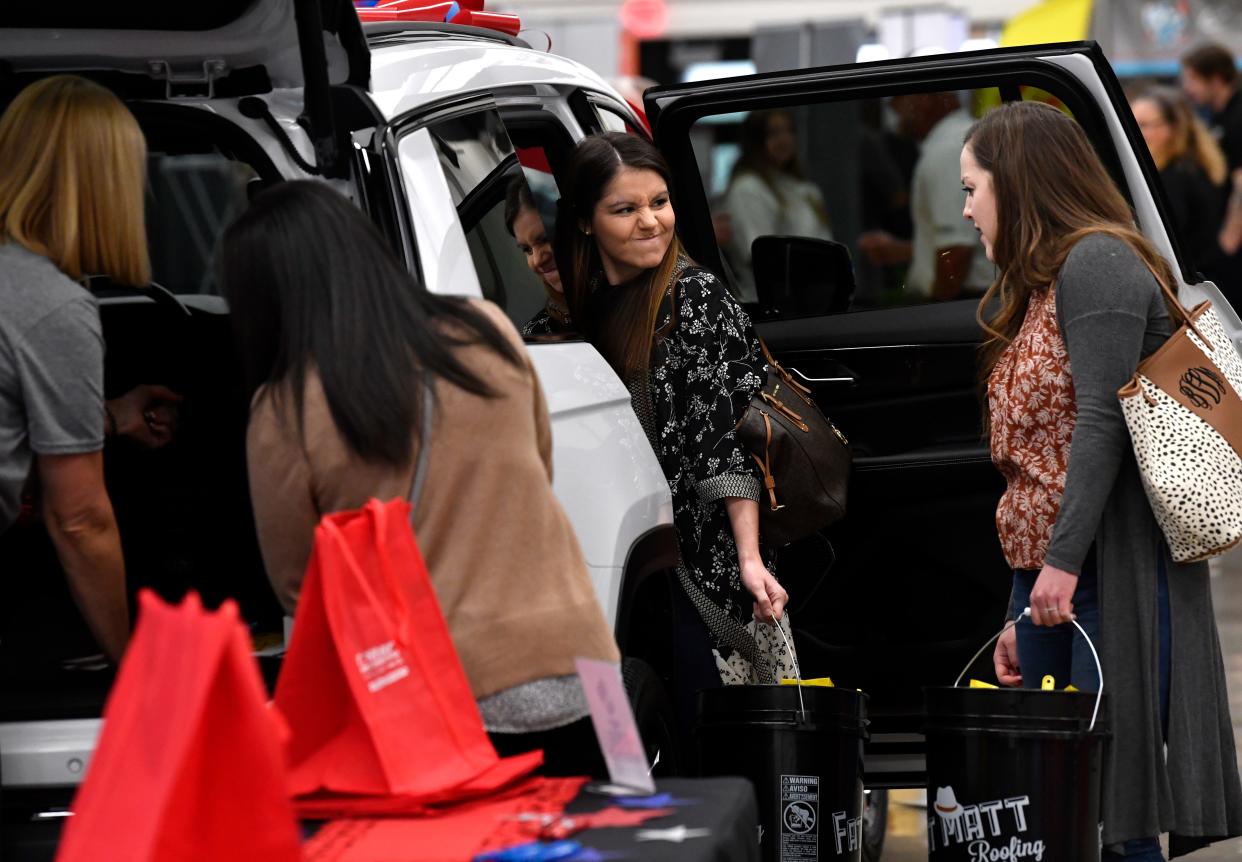 Rachel Wooden (center) looks to Brie Vine as they check out a vehicle with Maggie Brennan at Star Dodge booth at  Wednesday's Business Expo at the Abilene Convention Center.