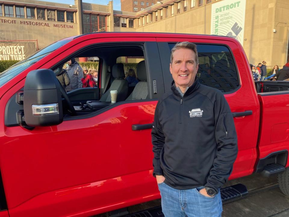 Peter Bejin, a Ford engineer, waits by the all-new Ford Super Duty he helped create before America's Thanksgiving Parade in Detroit on Thursday, Nov. 24, 2022.