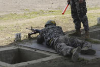 In this undated photo provided by South Korea Marine Corps' Facebook on Friday, May 8, 2020, Tottenham Hotspur forward Son Heung-min takes part in shooting drill at a Marine Corps boot camp in Seogwipo on Jeju Island, South Korea. Son finished his three-week military training in South Korea on Friday and was right near the top of the class.(South Korea Marine Corps' Facebook via AP)