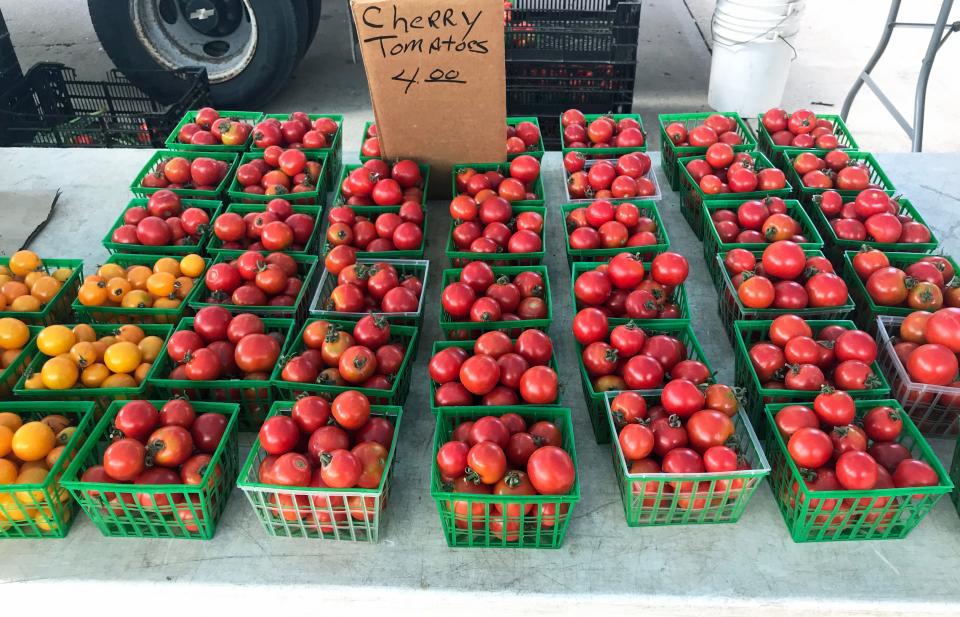 Boxes of cherry tomatoes wait for buyers at the West Allis Farmers Market.