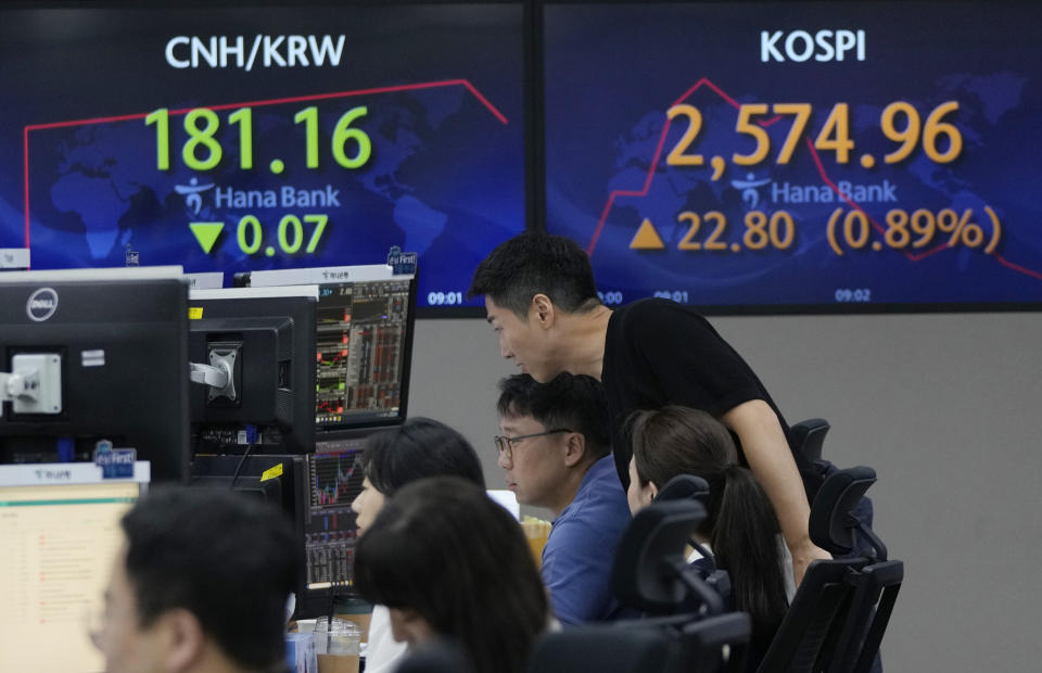 Currency traders watch monitors near the screens showing the Korea Composite Stock Price Index (KOSPI), top right, at the foreign exchange dealing room of the KEB Hana Bank headquarters in Seoul, South Korea, Wednesday, Aug. 30, 2023. Asian shares rose Wednesday, boosted by a Wall Street rally that came on positive reports on consumer confidence and job openings.(AP Photo/Ahn Young-joon)