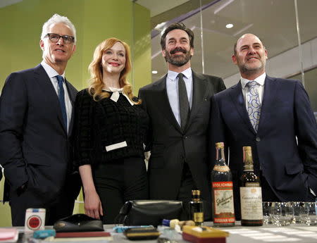 "Mad Men" stars (L-R) John Slattery, Christina Hendricks and Jon Hamm along with series creator Matthew Weiner (R) stand behind props from the show during a donation ceremony at the Smithsonian National Museum of American History in Washington March 27, 2015. REUTERS/Kevin Lamarque