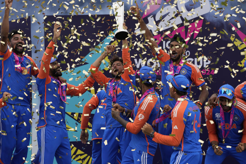 Indian players celebrate with the winners trophy after defeating South Africa in the ICC Men's T20 World Cup final cricket match at Kensington Oval in Bridgetown, Barbados, Saturday, June 29, 2024. (AP Photo/Ricardo Mazalan)