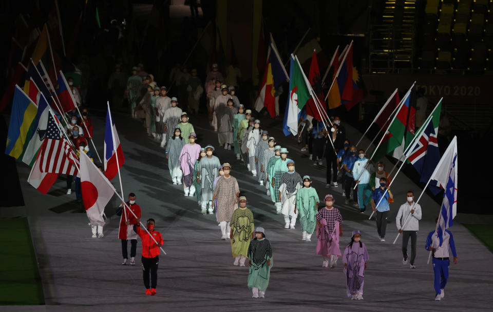 TOKYO, JAPAN - AUGUST 8, 2021: Athletes with national flags are seen during the closing ceremony of the 2020 Summer Olympic Games at the Japan National Stadium (a.k.a the Olympic Stadium). The Olympic Games were held amid the COVID-19 pandemic. The closing ceremony features live and pre-recorded elements. Stanislav Krasilnikov/TASS (Photo by Stanislav Krasilnikov\TASS via Getty Images)
