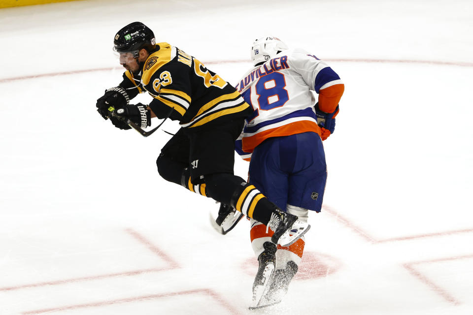 Boston Bruins' Brad Marchand, left, collides with New York Islanders' Anthony Beauvillier in the second period of Game 2 during an NHL hockey second-round playoff series, Monday, May 31, 2021, in Boston. (AP Photo/Winslow Townson)