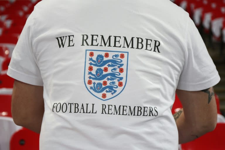 An England supporter poses in a t-shirt with the three lions and poppy symbol to represent the war dead