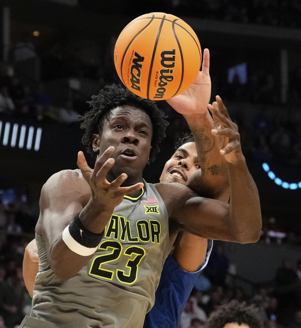 Baylor forward Jonathan Tchamwa Tchatchoua (23) and UC Santa Barbara forward Andre Kelly (2) battle for a loose ball during the second half of a first-round college basketball game in the men's NCAA Tournament Friday, March 17, 2023, in Denver. (Chris Jones/Waco Tribune-Herald via AP)