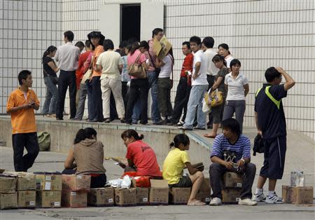 Local residents stand in lines at the headquarters of the Sanlu Group to receive a refund on their milk powder products in the city of Shijiazhuang, located around 300 km (186 miles) southwest of Beijing in this September 16, 2008 file photo. REUTERS/David Gray/Files
