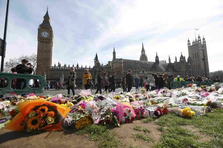 Floral tributes are seen in Parliament Square, following the attack in Westminster earlier in the week, in London, Britain March 25, 2017. REUTERS/Peter Nicholls