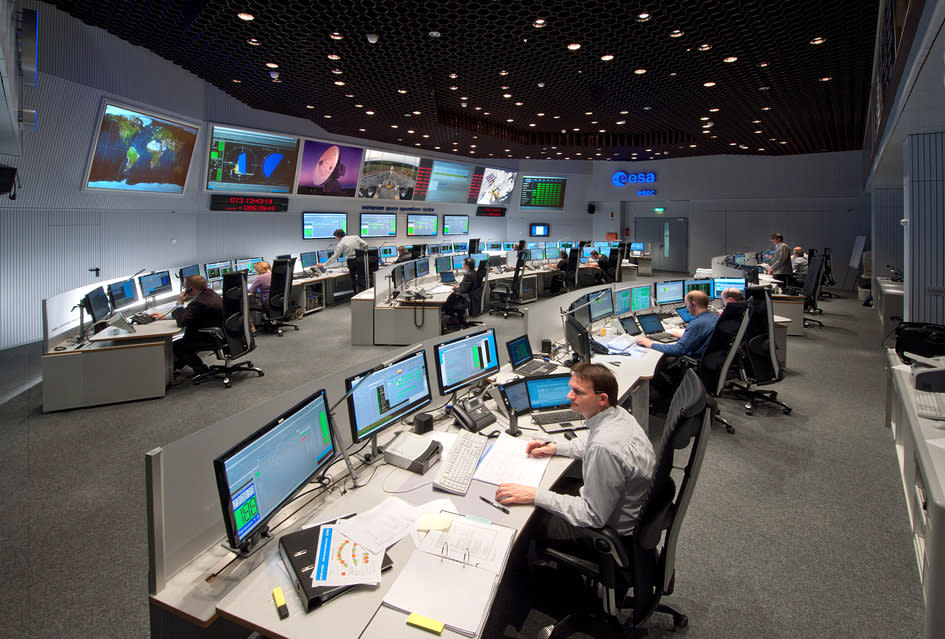 FILE - In this 2013 file photo provided by the European Space Agency, ESA, employees work in the control room of ESA in Darmstadt, Germany. Scientists at the European Space Agency are expecting their comet-chasing probe Rosetta to wake from almost three years of hibernation at 11 a.m. Monday Jan. 20, 2014 (1000 GMT; 5 a.m. EST) and phone home to say all is well. (AP Photo/ESA, Juergen Mai, File)