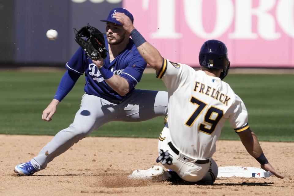 Los Angeles Dodgers' Gavin Lux tags out Milwaukee Brewers' Sal Frelick at second on a stolen base attempt during the second inning of a spring training baseball game Saturday, Feb. 25, 2023, in Phoenix. (AP Photo/Morry Gash)