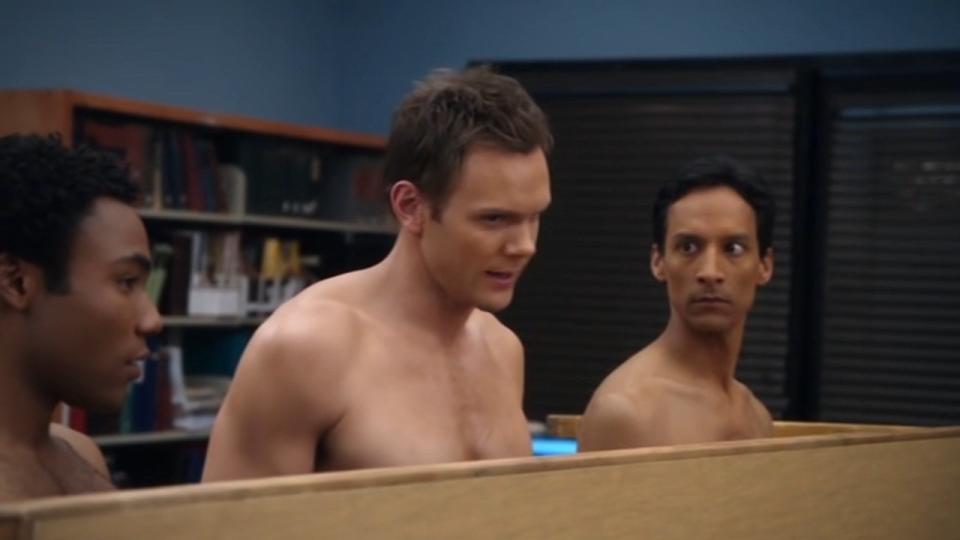 Troy, Jeff, and Abed standing in their underwear behind an overturned table in "Community"