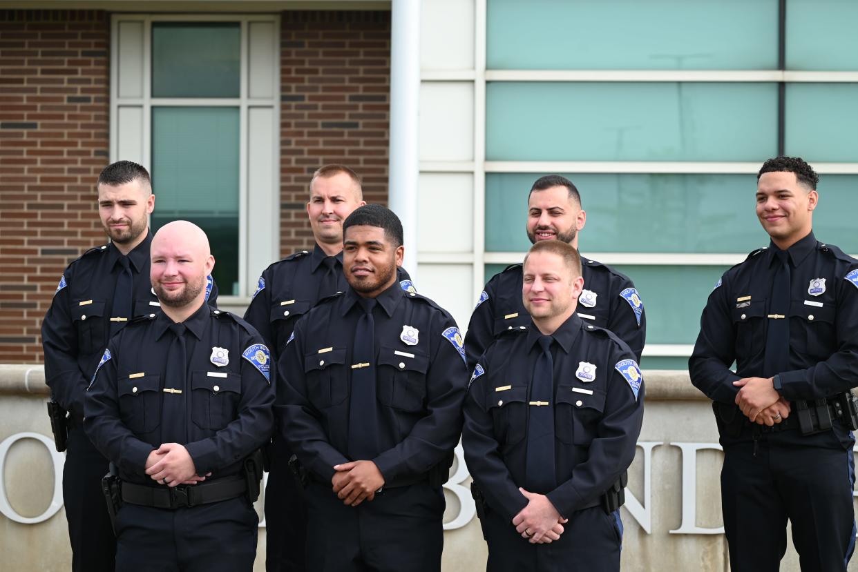 Seven new South Bend Police officers (front, left to right) Nicholas Hess, Nathaniel Taborn, Jeffrey Rose (back, left to right) Eric Vargo, Daniel Kurz, Thomas Petrizzo and Brandon Clark stand outside the South Bend Police Department on May 15, 2024.