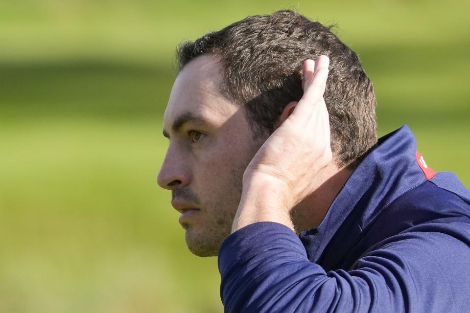 Team USA's Patrick Cantlay tries to get the crowd going on the ninth hole during a foursomes match the Ryder Cup at the Whistling Straits Golf Course Saturday, Sept. 25, 2021, in Sheboygan, Wis. (AP Photo/Charlie Neibergall)