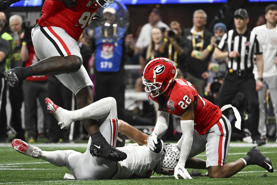 Georgia defensive back Javon Bullard (22) sacks Ohio State quarterback C.J. Stroud (7) during the second half of the Peach Bowl NCAA college football semifinal playoff game, Saturday, Dec. 31, 2022, in Atlanta. (AP Photo/Danny Karnik)