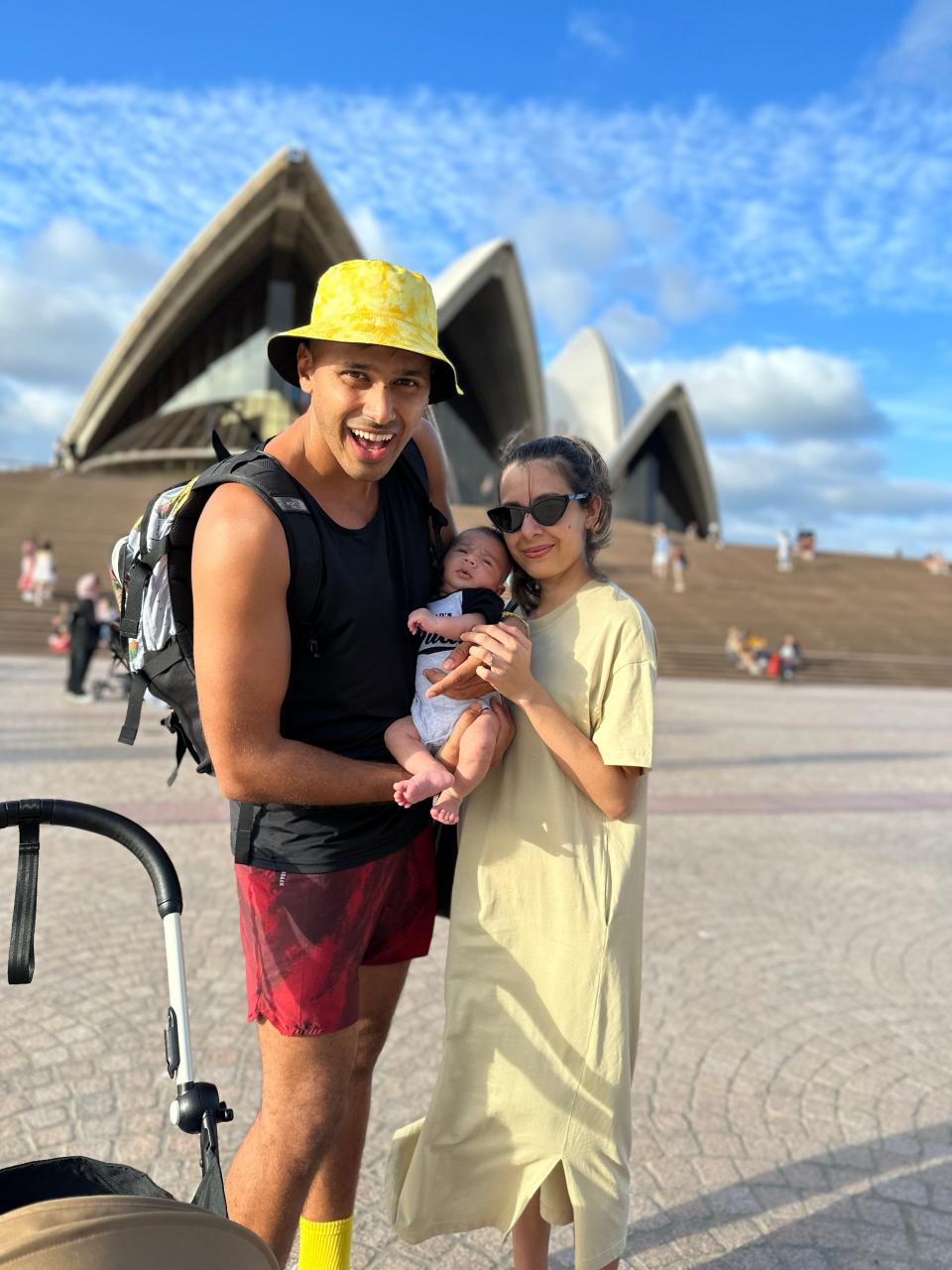 A young family outside the Sydney Opera house.