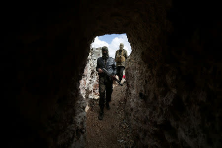 Syrian rebel fighters walk through a tunnel they said belonged to Islamic State fighters which connects the northern Syrian city of al-Bab to Aqeel mountain. REUTERS/Khalil Ashawi