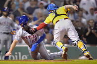 New York Mets' Pete Alonso, left, is tagged out by Boston Red Sox catcher Christian Vazquez while trying to score on a single by Michael Conforto during the fourth inning of a baseball game at Fenway Park, Tuesday, Sept. 21, 2021, in Boston. (AP Photo/Charles Krupa)