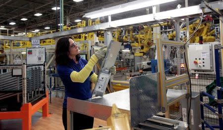 FCA assembly worker Anita Zaleski applies bar codes to parts for the all-new 2017 Chrysler Pacifica minivan at the FCA Windsor Assembly plant in Windsor, Ontario, May 6, 2016. REUTERS/Rebecca Cook