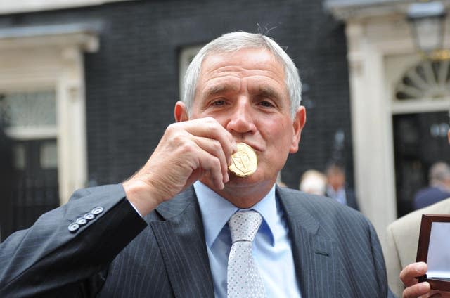 Norman Hunter kisses his winners' medal from the 1966 World Cup