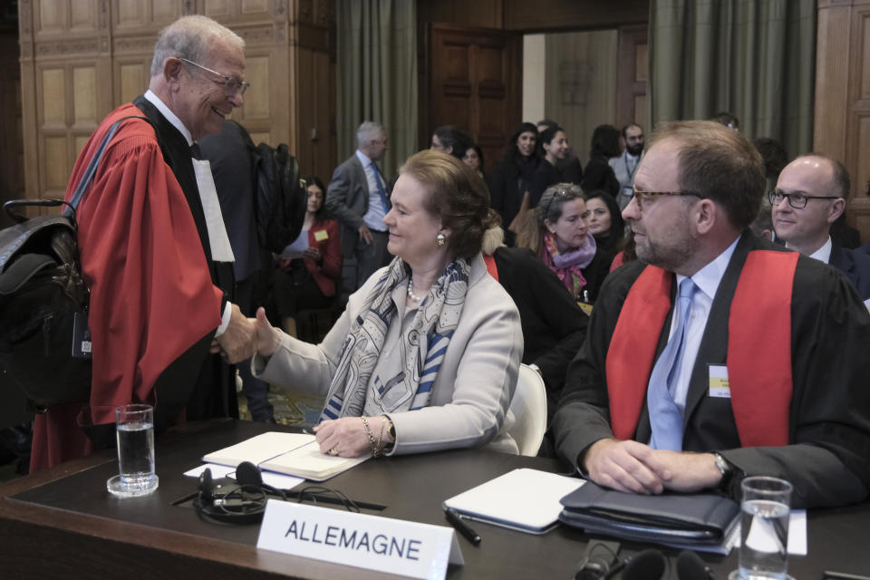 Tania von Uslar-Gleichen, Germany's legal adviser and Director-General for Legal Affairs of the German Foreign Ministry, center, shakes hands with Alain Pellet, left, a lawyer representing Nicaragua, prior to the start of a two days hearing at the World Court in The Hague, Netherlands, Monday, April 8, 2024, in a case brought by Nicaragua accusing Germany of breaching the genocide convention by providing arms and support to Israel. (AP Photo/Patrick Post)
