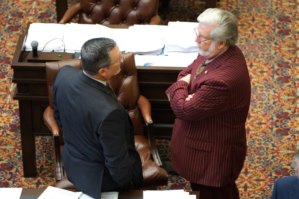 Sens. Chuck Hall, left, and Roger Thompson visit May 26, 2023, on the floor during activity for the last day of the 2023 legislative session at the Capitol.