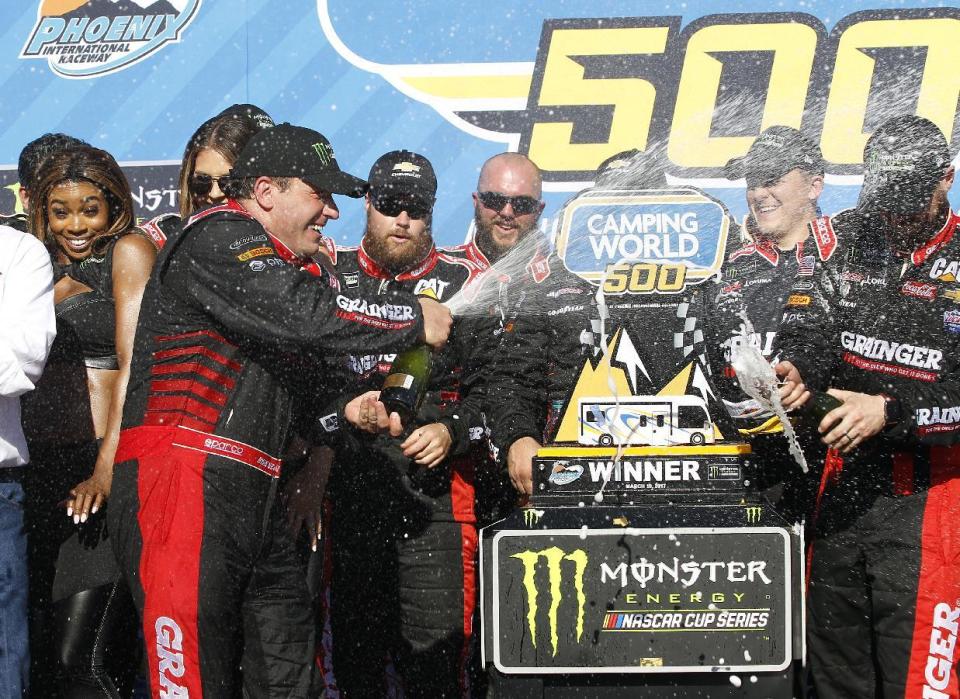 Ryan Newman, left, celebrates with his crew in Victory Lane after winning the NASCAR Cup Series auto race at Phoenix International Raceway, Sunday, March 19, 2017, in Avondale, Ariz. (AP Photo/Ralph Freso)