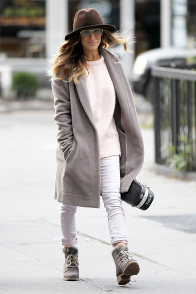 Sarah Jessica Parker: SJP slips on something a bit warmer (although with the coat wide open, we're not sure how warm it can be). The boxy dove grey coat over a loose light pink sweater and rolled up skinny jeans over combat boots is a cute look for winter. The light colours are refreshing when we're used to seeing a sea of drab black. Picture by: Christopher Peterson / Splash News