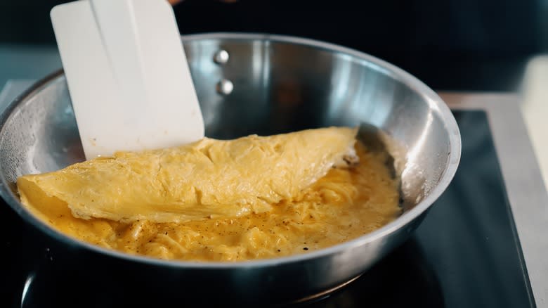 cooking french omelet on stove