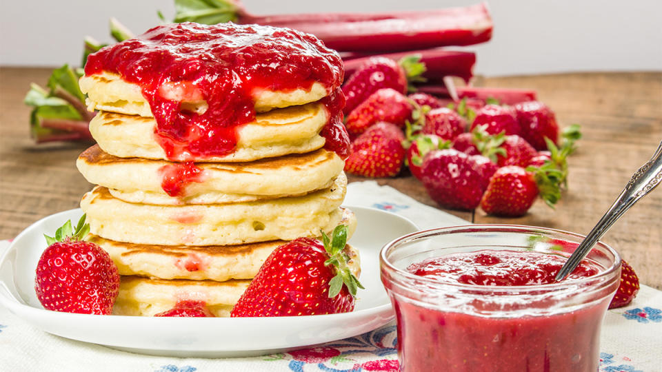 Strawberry rhubarb jam drizzled over pancakes