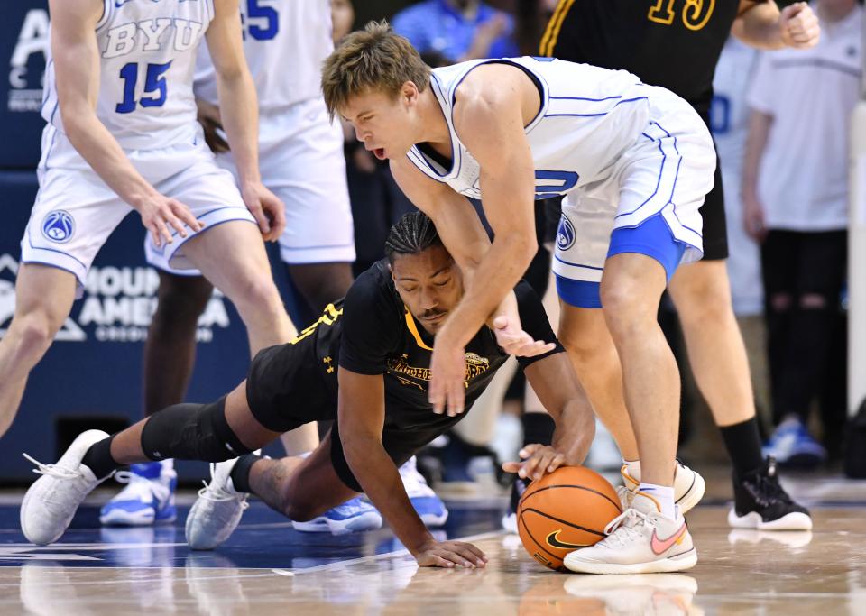 Southeastern Louisiana Lions guard Alec Woodard (20) and Brigham Young Cougars guard Dallin Hall (30) chase the ball as BYU and SE Louisiana play at the Marriott Center in Provo on Wednesday, Nov. 15, 2023. BYU won 105-48. | Scott G Winterton, Deseret News