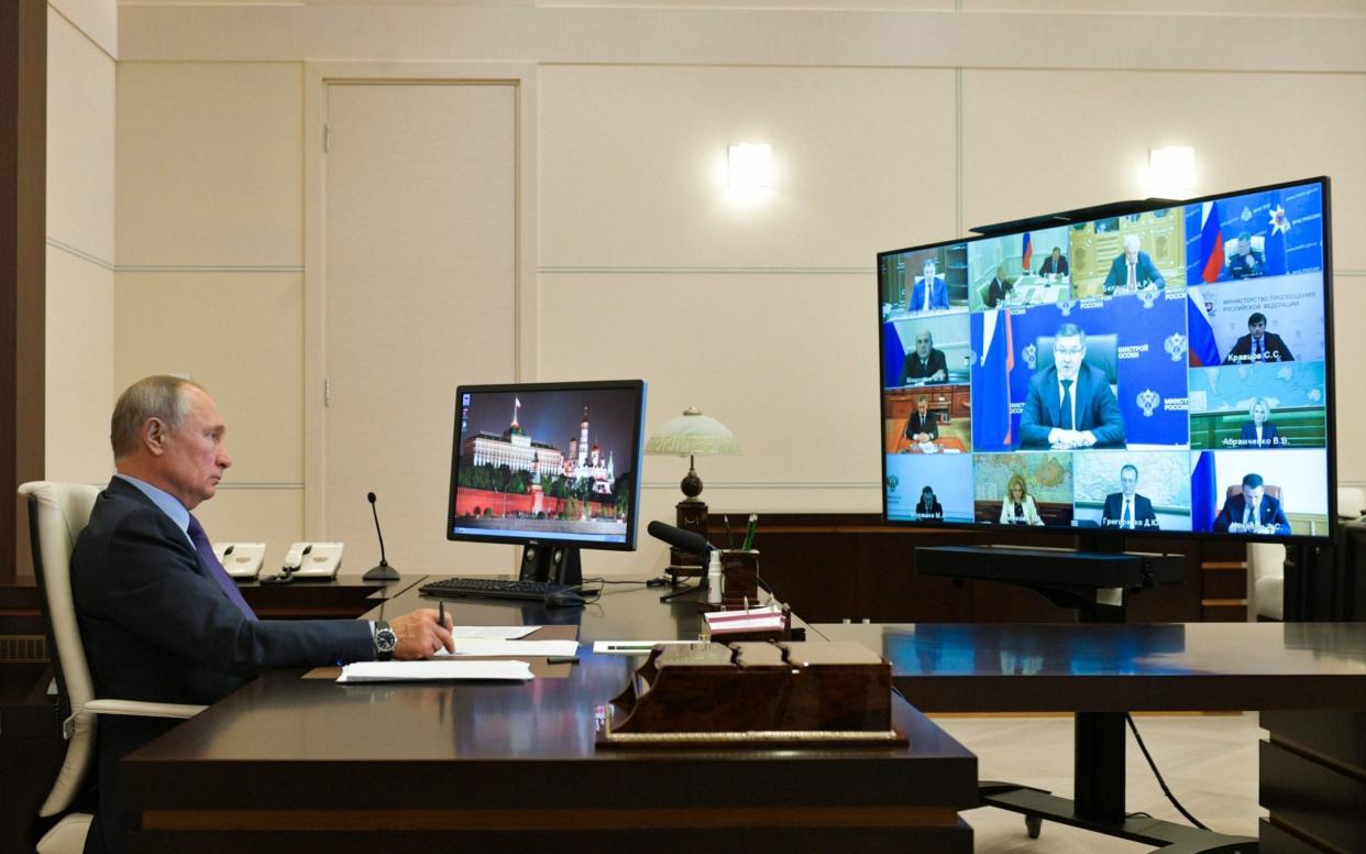 While Russians largely went back to a normal life this summer, President Vladimir Putin stays put at his out-of-town residence and holds most of his meetings by video conference - Alexei Druzhinin/Sputnik via AFP